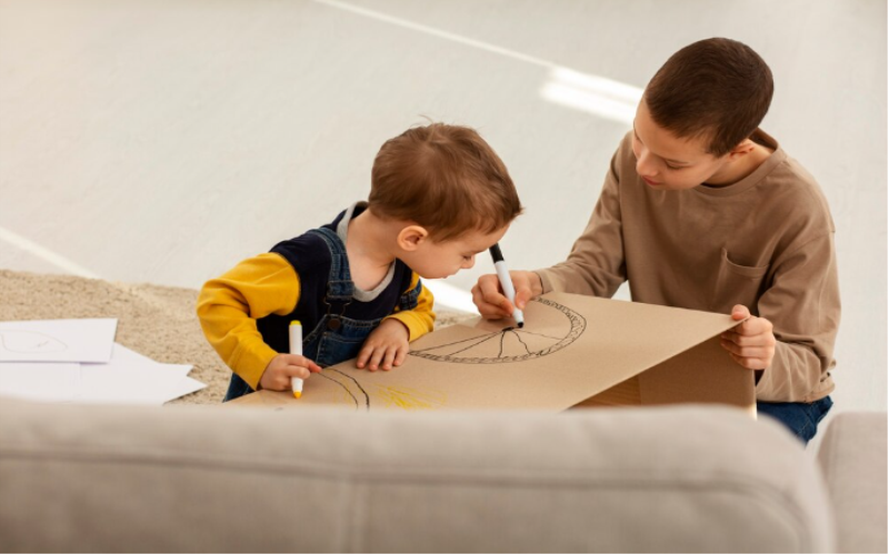 children making obstacle courses using boxes